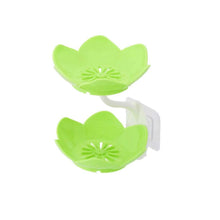 Flower-shaped soap dish, self-draining for use in bathroom, kitchen, or bathtub.